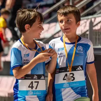 Deux jeunes de l'école d'athlétisme de l'OM avec leur médaille